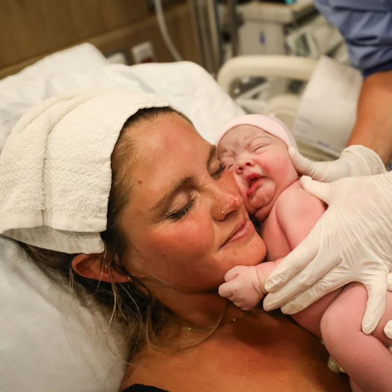 A mother's joy meeting her newborn, photographed by Jenn Miller
