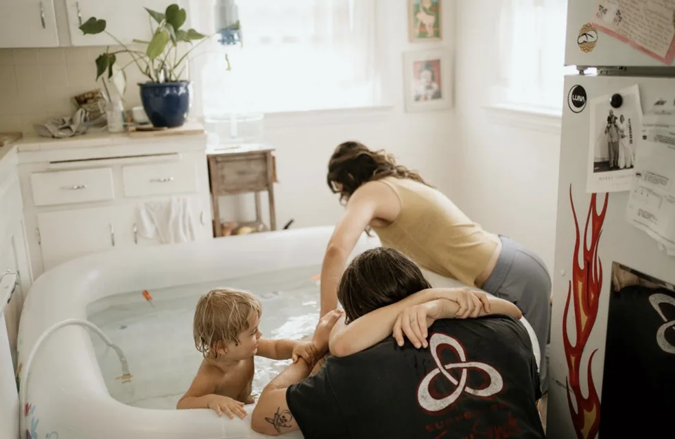 Jenn Miller supporting a family at a home birth pool